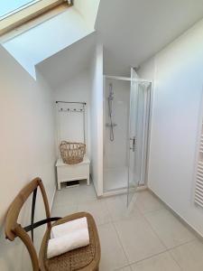 a bathroom with a shower and a chair at Ty kergo in Surzur +31 photos