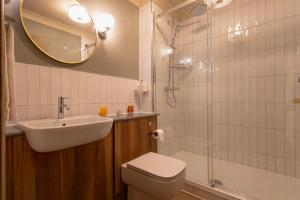 a bathroom with a sink and a toilet and a shower at The Red Lion Hawkshaw in Bury +37 photos