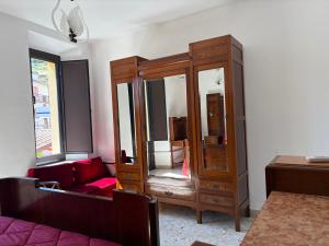 a living room with a wooden cabinet and a couch at Casa Caterina in Graniti