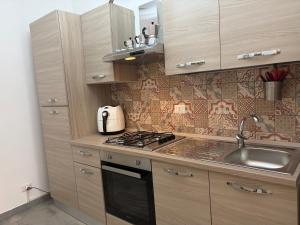 a kitchen with a sink and a stove top oven at Casa Caterina in Graniti