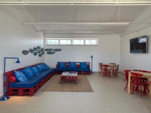 a living room with a blue couch and a table at Parque De Campismo Orbitur Sao Pedro De Moel in São Pedro de Moel