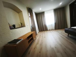 a living room with a couch and a wooden floor at Under Rock Guesthouse in Bled