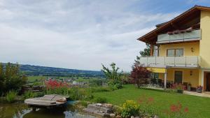 a house with a pond in the yard at Haus Margit in Schlierbach