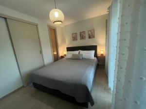 a bedroom with a bed with two pillows at Aegean View House Plomari in Plomari