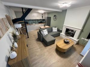 a living room with a couch a table and a fireplace at Aegean View House Plomari in Plomari