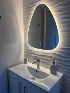 a bathroom with a sink and a mirror at Aegean View House Plomari in Plomari