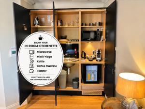 a sign in a room with a microwave and a coffee machine at Hillside Farm Barn in Woking