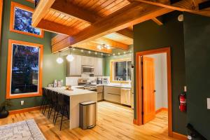 a kitchen with green walls and a white counter top at Whistler Peak Lodge in Glacier