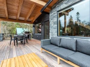 a living room with a couch on a wooden deck at Whistler Peak Lodge in Glacier