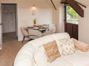 a living room with a white couch and a table at Granary in Pickering