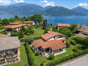 an aerial view of a house with a lake at Villa dei Mumi in Luino
