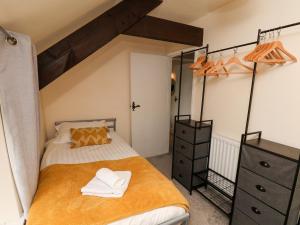 a bedroom with a bed with an orange blanket and a dresser at Granary in Pickering +58 photos