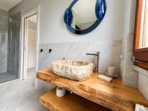 a bathroom with a stone sink and a mirror at Villa dei Mumi in Luino +31 photos