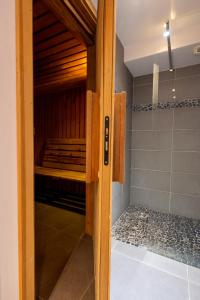 a wooden door to a sauna in a room at Le Flocon d'Argent in Les Gets +60 photos