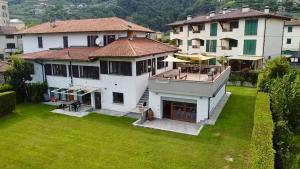 an aerial view of a house with a green yard at Casa Mario Spacious Garden Apartments, Lake Como in Domaso