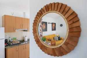 a kitchen and a living room with a mirror at Apartamentos Bellavista in Puerto del Carmen