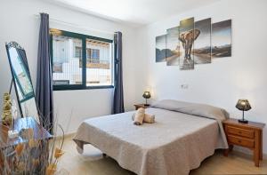 a bedroom with a bed with a teddy bear on it at Apartamentos Bellavista in Puerto del Carmen +120 photos