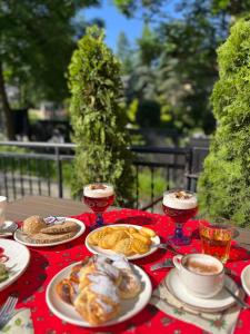 a table with plates of food and glasses of wine at Ośrodek Wypoczynkowy Start in Zakopane