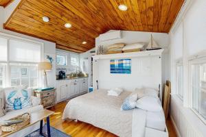 a bedroom with a bed and a wooden ceiling at The Atlantic in Yarmouth
