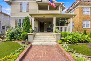 a house with an american flag on the front of it at The Classy Craftsman - Beautiful Decor & Pool in Atlanta