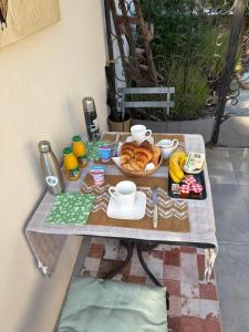 a table with a tray of food and a plate of bread at CHAMBRE d'HOTES POUR 2 PERSONNES in Peymeinade +4 photos
