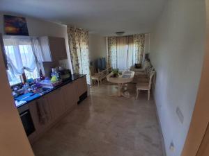 a kitchen and a living room with a table at Marina Bay in Kranevo