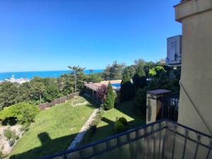 a view from the balcony of a house with a yard at Marina Bay in Kranevo
