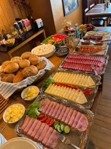 a buffet with many different types of food on a table at Bringenatten Hotell Nesbyen in Nesbyen