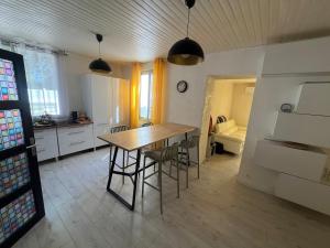 a kitchen with a table and chairs in a room at La Maison Blanche in Perpignan