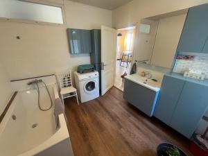 a bathroom with a sink and a washing machine at La Maison Blanche in Perpignan +10 photos