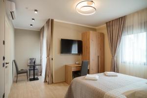 a bedroom with a bed and a flat screen tv at Da Niko in Treviso