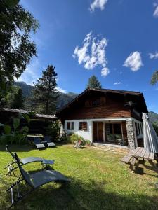 a house with a picnic table in the yard at Hôtel Le Jeu de Paume in Chamonix
