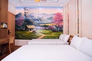 a room with two beds and a painting on the wall at Thong dong homestay&villas in Quỳnh Lưu +9 photos
