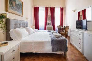a bedroom with a large bed with red curtains at Guesthouse Bel Duomo in Florence