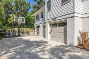 a house with a garage with a basketball hoop at 26th Ave 23 in Isle of Palms
