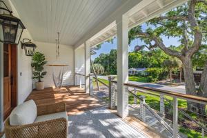 a porch with a swing and a tree at 26th Ave 23 in Isle of Palms