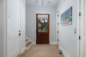a hallway with a door and a rug at 26th Ave 23 in Isle of Palms +44 photos