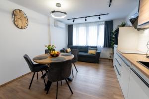 a kitchen and living room with a table and chairs at The Nest Otočac in Otočac