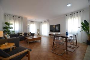 a living room with a couch and a table at Playa Grande SOLMARES in Isla del Moral