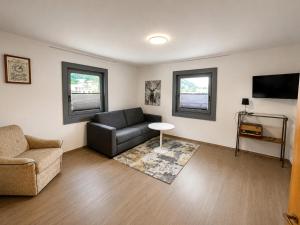 a living room with a couch and a chair at Haus am Stein in Stuhlfelden