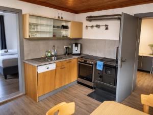 a kitchen with a sink and a stove top oven at Haus am Stein in Stuhlfelden +5 photos