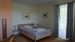 a bedroom with a bed and a window at Haus Margit in Schlierbach