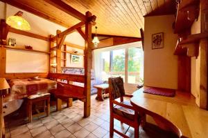 a living room with a table and a dining room at Les Toits des Cateaux in Combloux