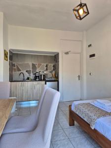 a bedroom with a bed and a kitchen at Galini Apartments in Bali