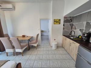 a kitchen and dining room with a table and chairs at Galini Apartments in Bali
