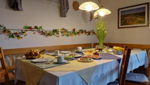 a table with a blue table cloth and food on it at Haus Margit in Schlierbach