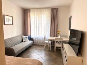 a living room with a couch and a table at Pottery Town Center Apartment in Bolesławiec