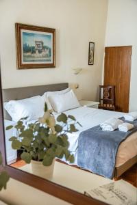 a bedroom with a bed and a potted plant on a table at Guesthouse Bel Duomo in Florence +90 photos