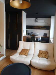 a living room with a white couch and a table at Autan-tic in Castres