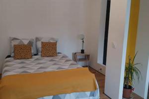 a bedroom with a bed with two pillows on it at Autan-tic in Castres